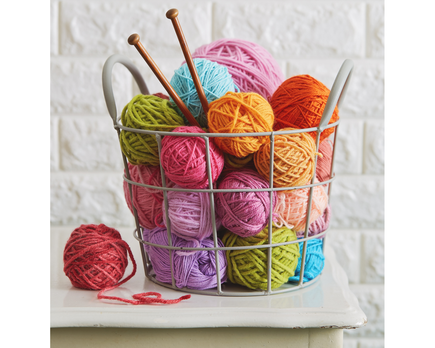 Yarn balls of different colors in a basket.