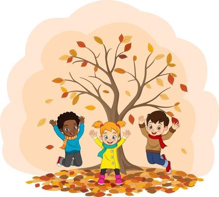 Three kids playing under a tree with fall leaves in a pile underneath.