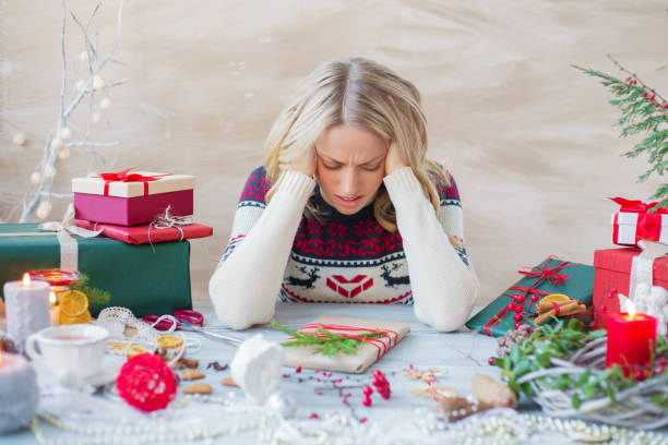 woman is distraught as she wraps gifts