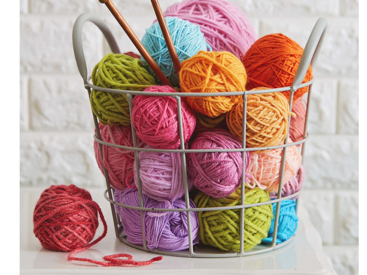 Yarn balls of different colors in a basket.